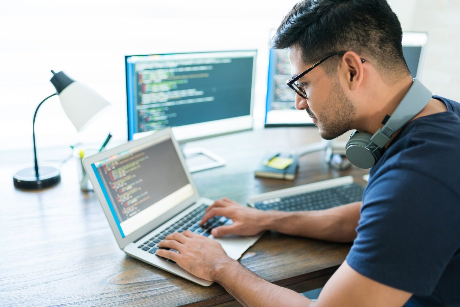 Side View Attractive Hispanic Developer Programming Software Using Computer While Working From Home Scaled 1